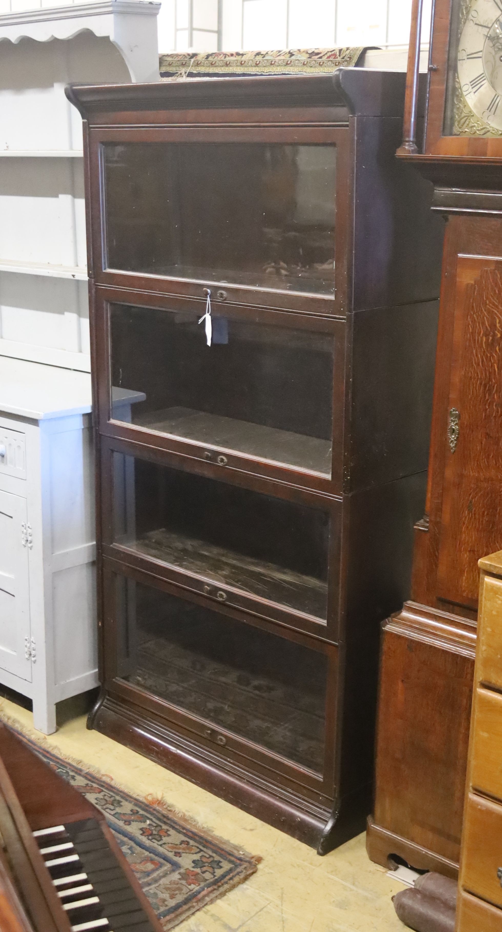 A Globe Wernicke style mahogany four section bookcase. W-86cm, D-36cm, H-172cm.